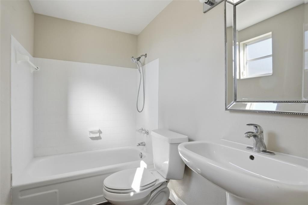 9543 Century Drive Spring Hill, FL 34608 - Photo 20 of 25 a bathroom with a sink a toilet and a bathtub