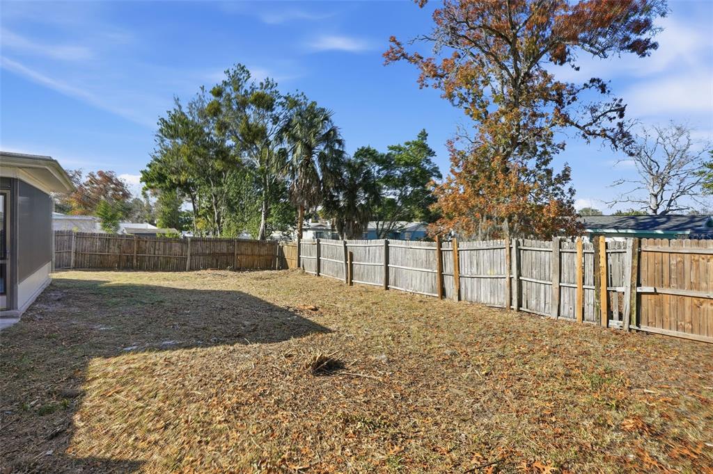 9543 Century Drive Spring Hill, FL 34608 - Photo 24 of 25 a view of a yard with wooden fence