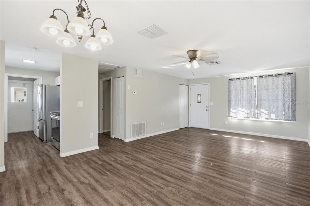 9543 Century Drive Spring Hill, FL 34608 - Photo 3 of 25 a view of an empty room with wooden floor and a large window