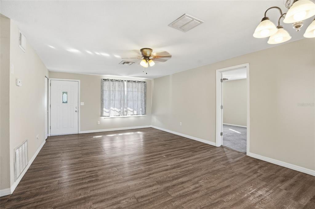 9543 Century Drive Spring Hill, FL 34608 - Photo 4 of 25 wooden floor in an empty room with a window