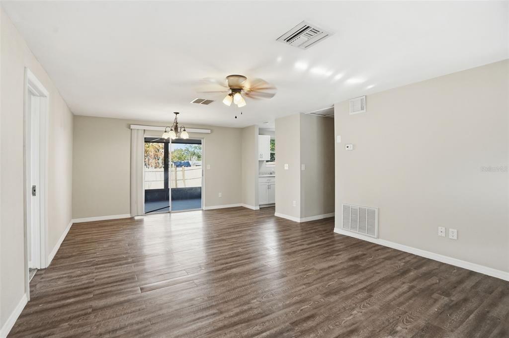 9543 Century Drive Spring Hill, FL 34608 - Photo 6 of 25 a view of an empty room with window and wooden floor