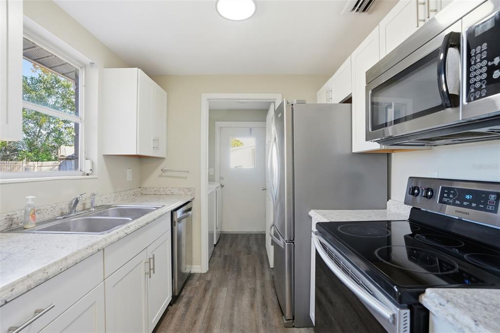 9543 Century Drive Spring Hill, FL 34608 - Photo 8 of 25 a kitchen with a sink stove and microwave