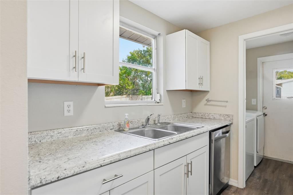 9543 Century Drive Spring Hill, FL 34608 - Photo 9 of 25 a kitchen with granite countertop white cabinets and a sink
