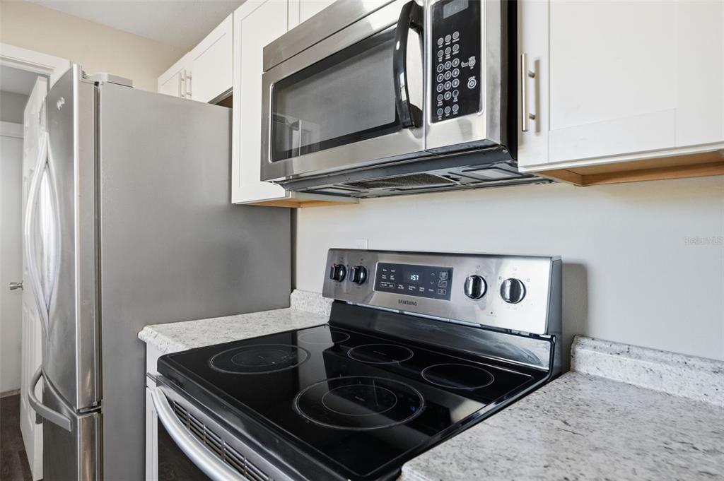 9543 Century Drive Spring Hill, FL 34608 - Photo 10 of 25 a kitchen with a stove and a microwave