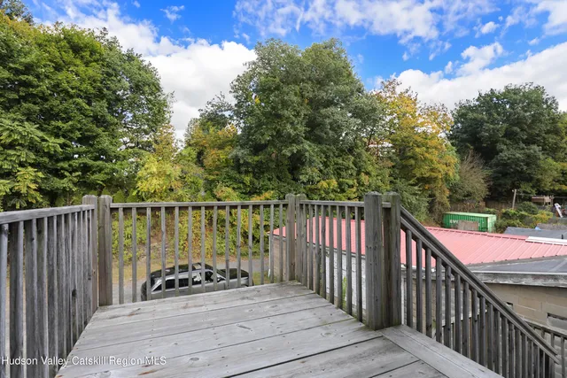 a balcony with wooden floor and outdoor space