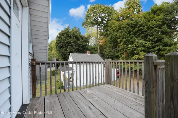 a view of balcony with wooden floor and fence