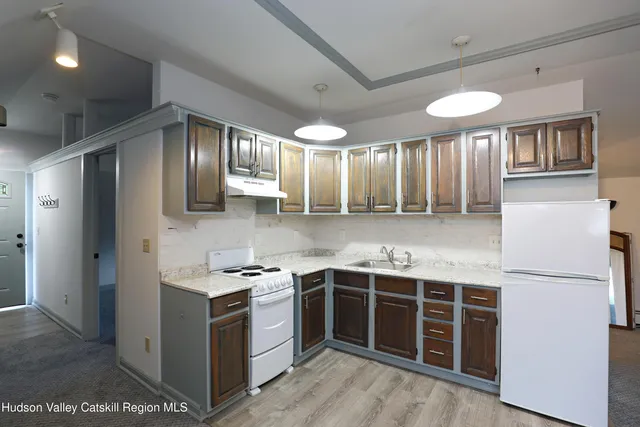 a kitchen with stainless steel appliances granite countertop a stove and a refrigerator
