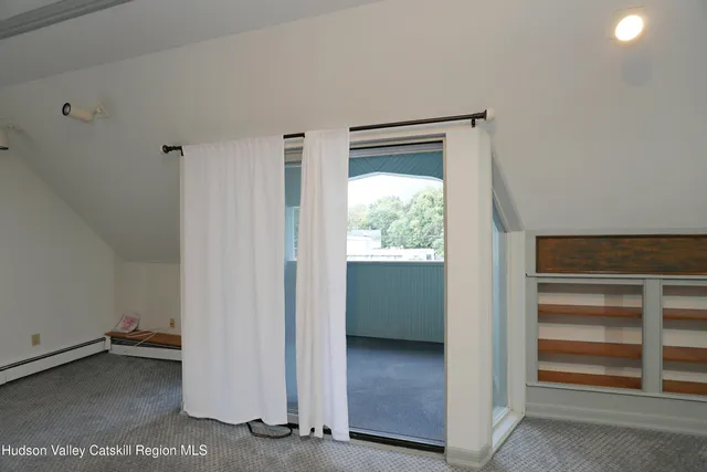 a view of an empty room and a window