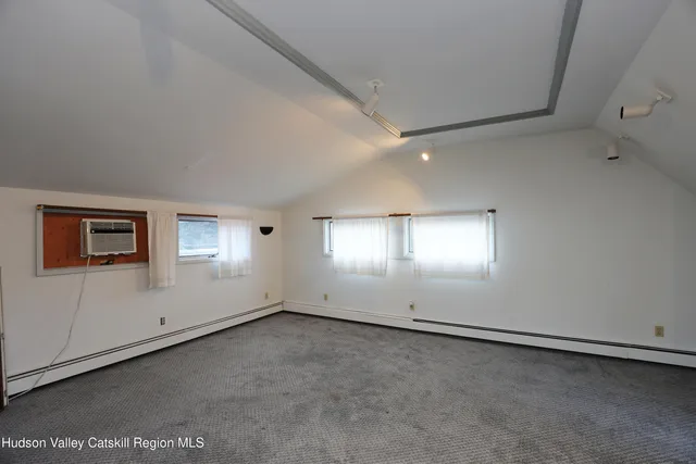 an empty room with a empty space and windows