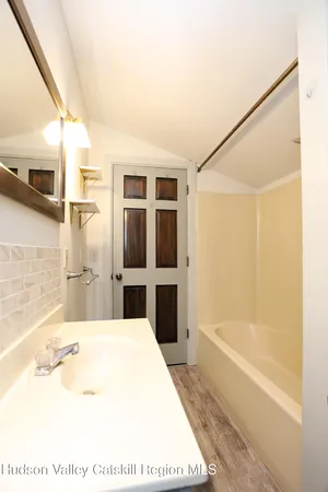 a bathroom with a tub and a shower