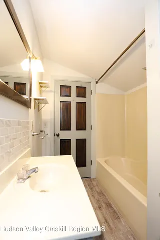 a bathroom with a tub and a shower