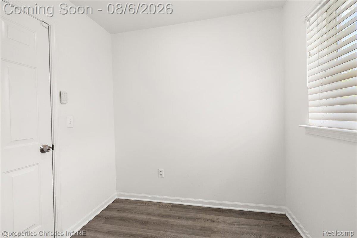 2500 Normandy Road, Unit 38 Royal Oak, MI 48073 - Photo 15 of 55 Room featuring wood-finish flooring and a white paneled door with brushed nickel hardware