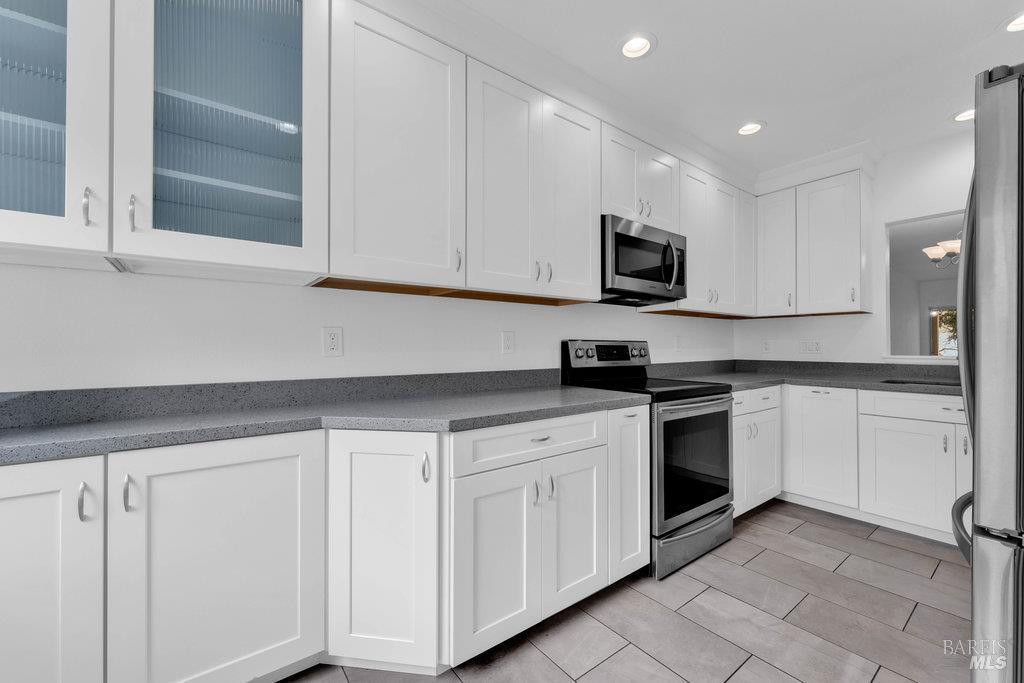 135 Koch Road Corte Madera, CA 94925 - Photo 17 of 57 a kitchen with granite countertop white cabinets and stainless steel appliances