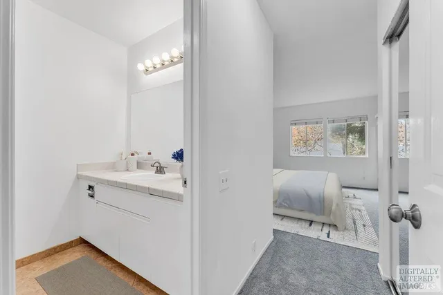 a bedroom with a bed and large window