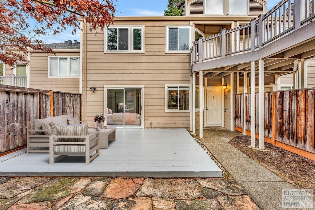 135 Koch Road Corte Madera, CA 94925 - Photo 3 of 57 a view of a patio with couches chairs and floor to ceiling window with wooden floor