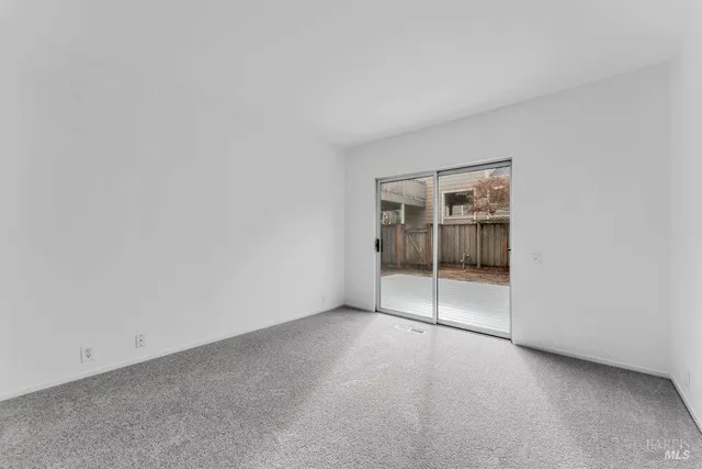 a bedroom with furniture and a large window