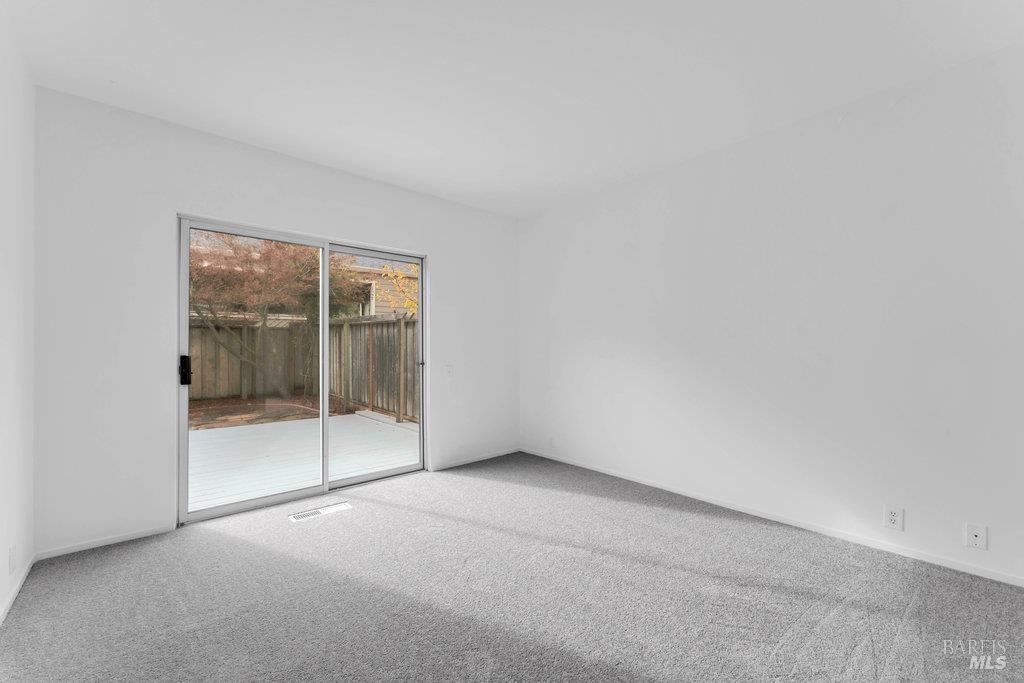 135 Koch Road Corte Madera, CA 94925 - Photo 44 of 57 an empty room with sliding glass door