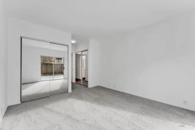 a view of a house with a wooden fence