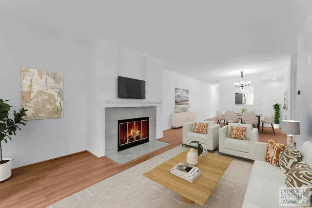 a view of empty room with wooden floor and fireplace