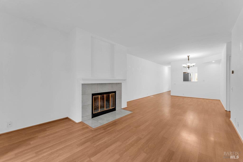 135 Koch Road Corte Madera, CA 94925 - Photo 10 of 57 a view of empty room with wooden floor and fireplace