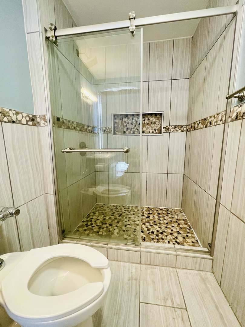 1451 East 55th Street, Unit 1030N Chicago, IL 60615 - Photo 13 of 18 a bathroom with a sink and a shower