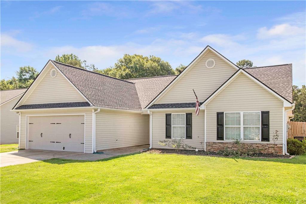 312 Oliver Ridge Drive Commerce, GA 30529 - Photo 1 of 1 a view of a house with a yard and a garage