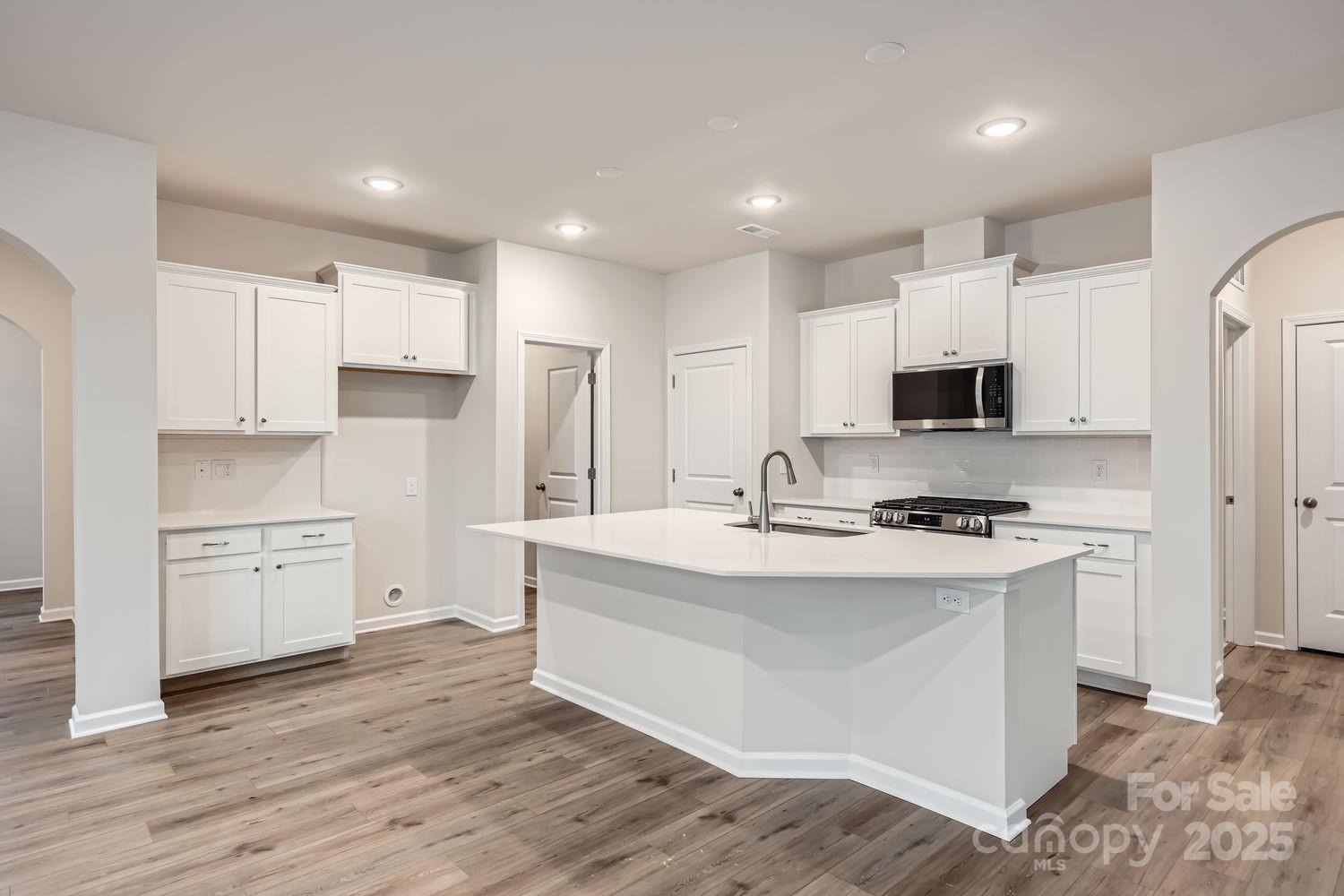 5720 Olive Bch Road Kannapolis, NC 28081 - Photo 5 of 13 a kitchen with stainless steel appliances a stove top oven a sink and a refrigerator