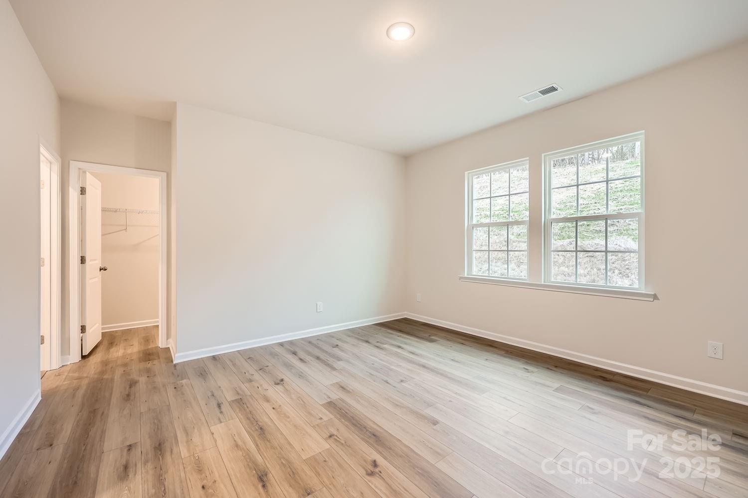 5720 Olive Bch Road Kannapolis, NC 28081 - Photo 7 of 13 an empty room with wooden floor and windows