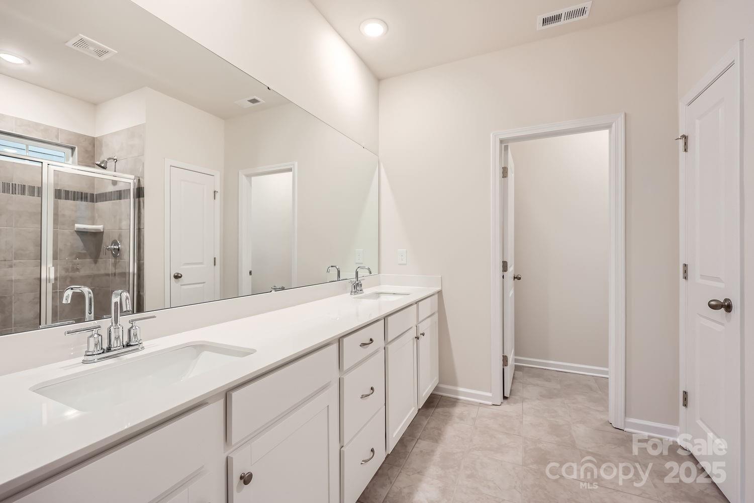5720 Olive Bch Road Kannapolis, NC 28081 - Photo 8 of 13 a spacious bathroom with a double vanity sink mirror and double