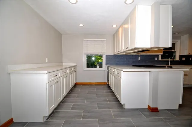 a kitchen with a sink stove and cabinets