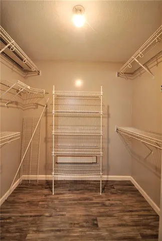 a view of a room with wooden floor and white walls