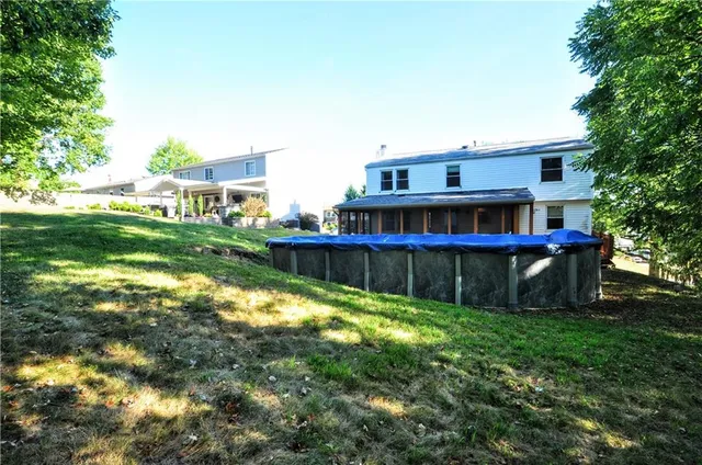 a view of a house with a yard and sitting area