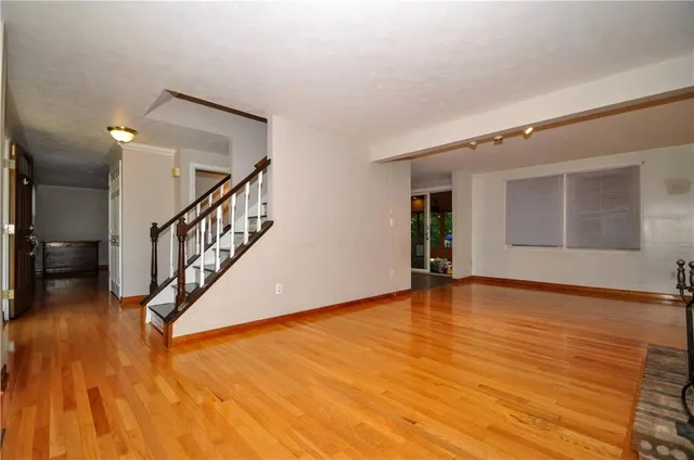 a view of an entryway with wooden floor