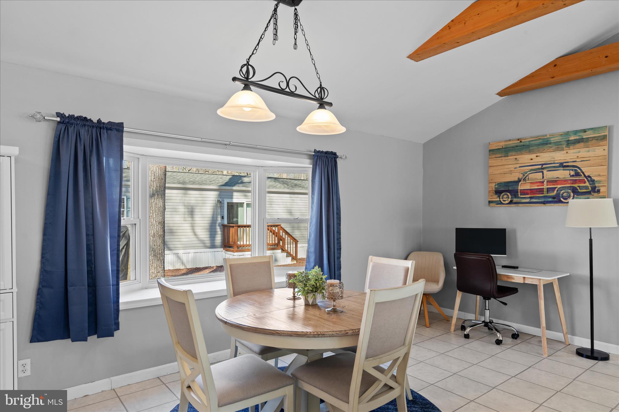 25760 Blue Ridge Street Millsboro, DE 19966 - Photo 13 of 64 a dining room with wooden floor a chandelier a wooden table and chairs