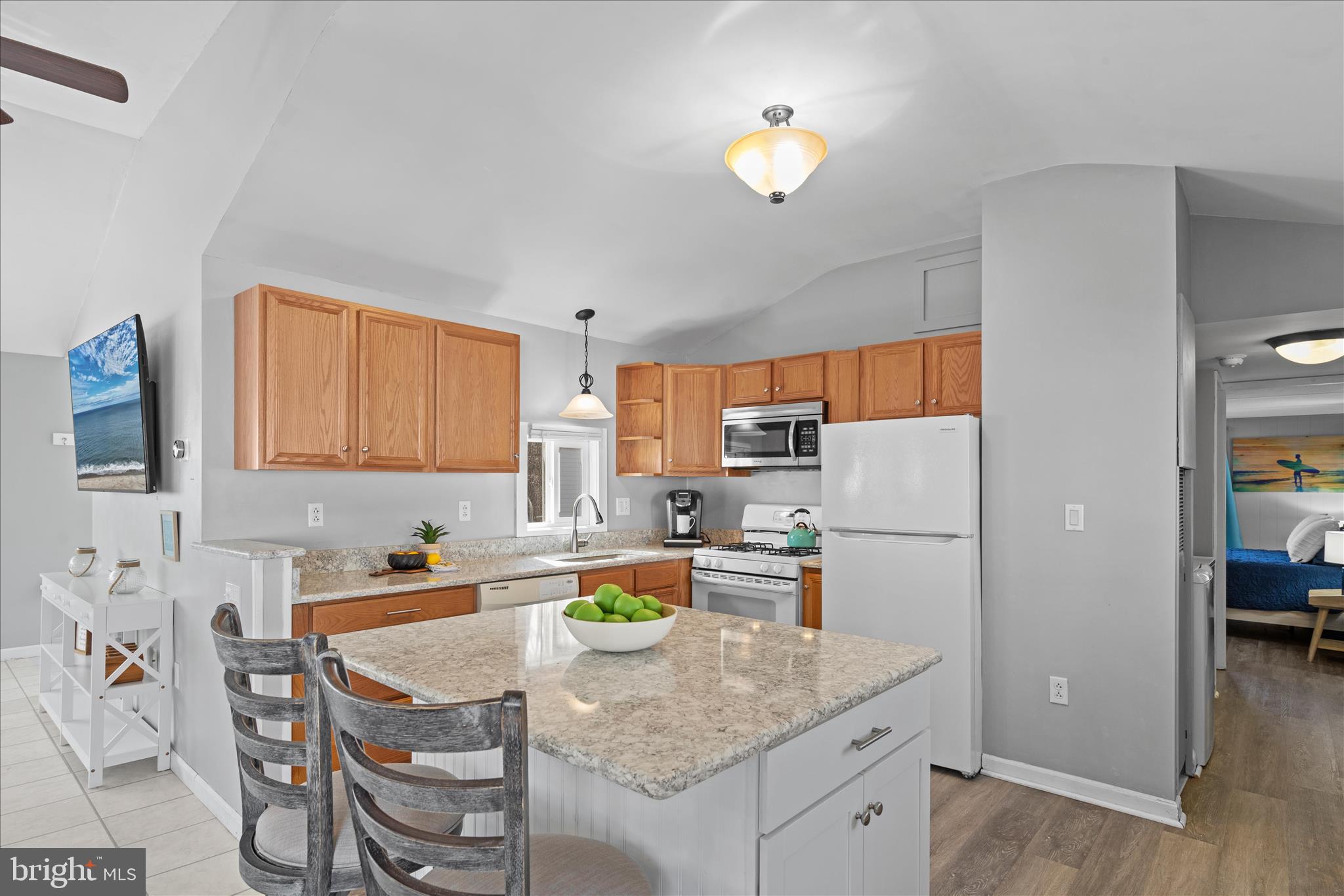 25760 Blue Ridge Street Millsboro, DE 19966 - Photo 17 of 64 a kitchen with a refrigerator a stove a sink dishwasher and white cabinets with wooden floor