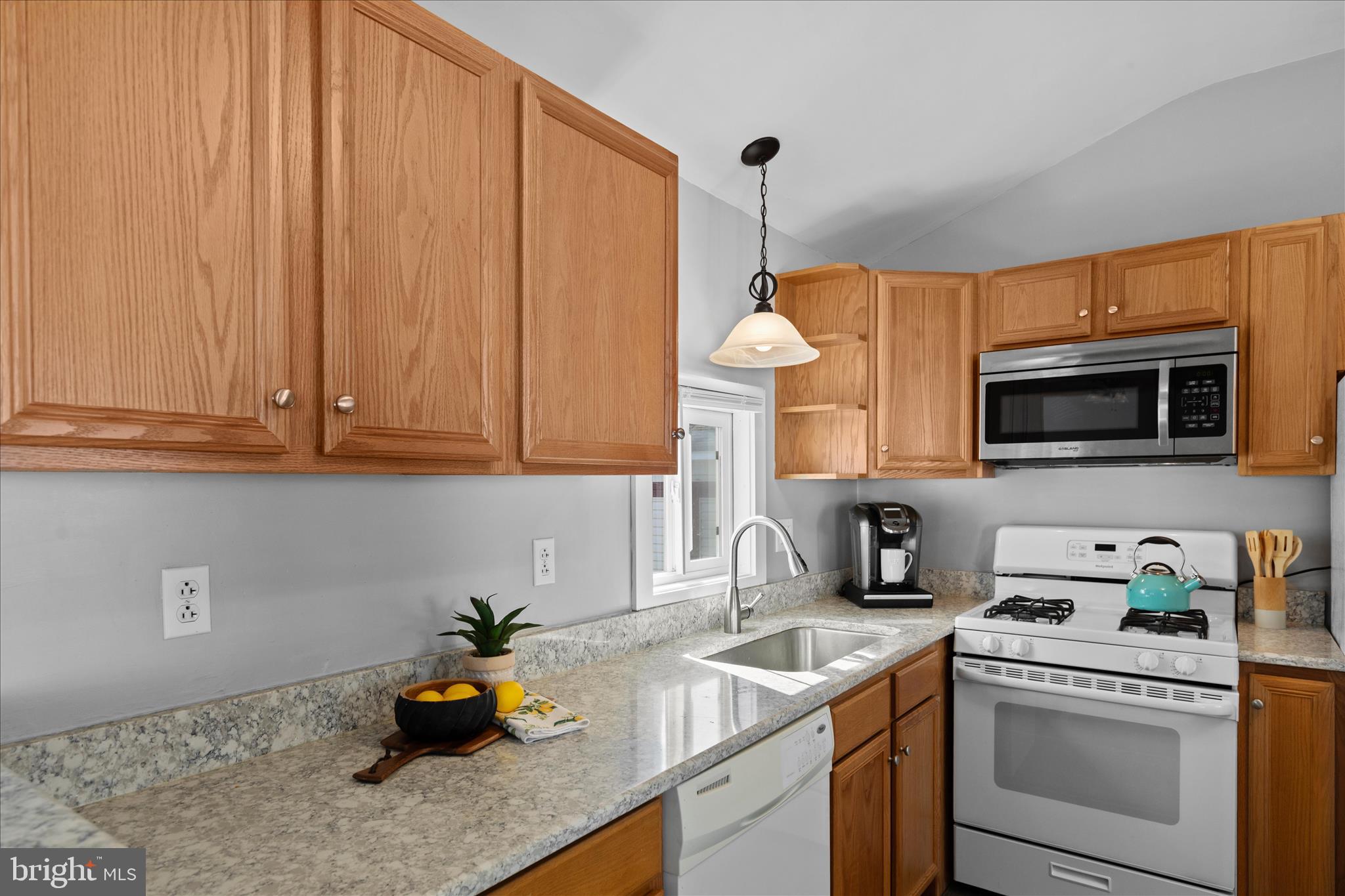 25760 Blue Ridge Street Millsboro, DE 19966 - Photo 23 of 64 a kitchen with stainless steel appliances granite countertop a sink a stove and a microwave