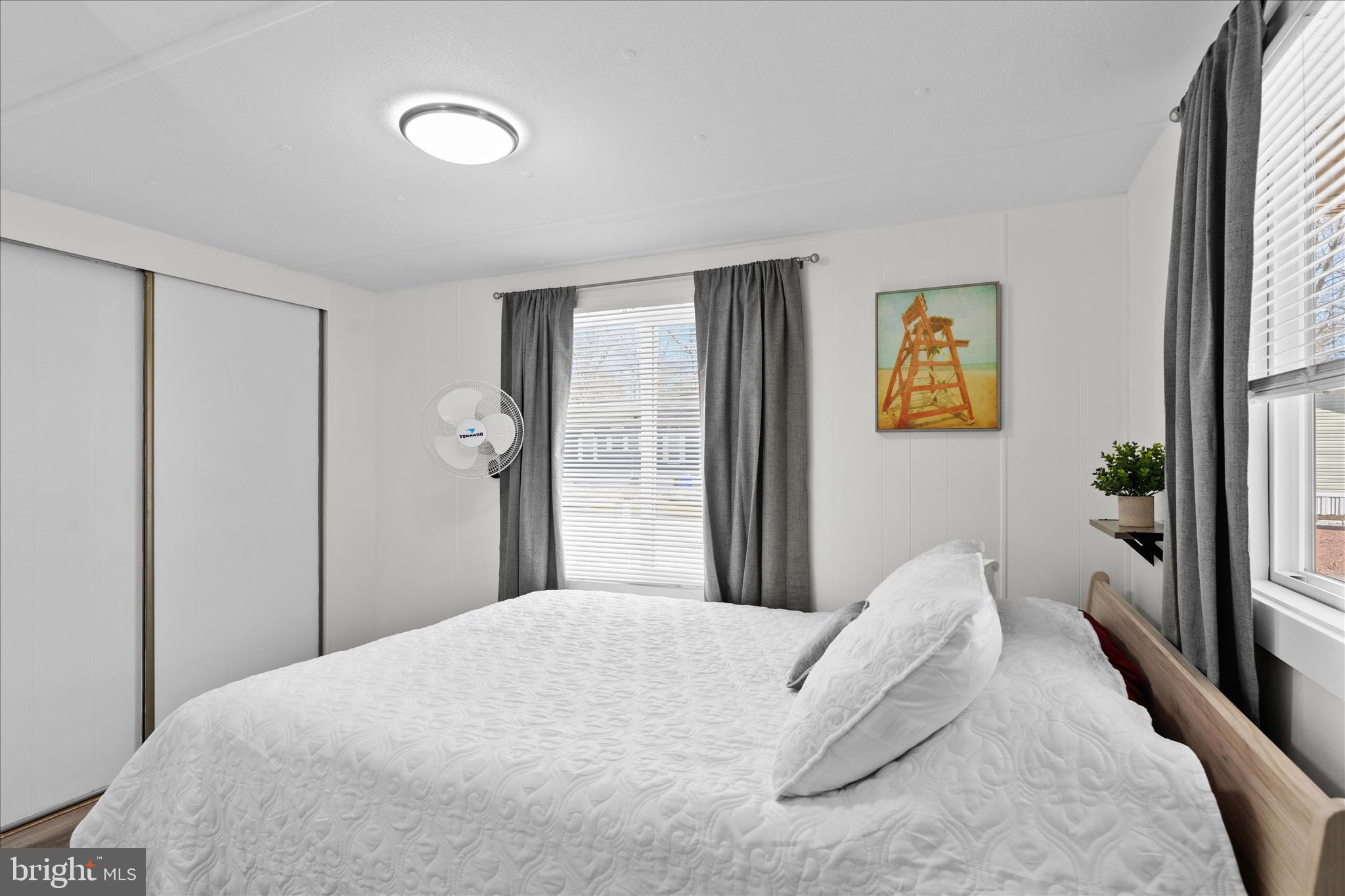 25760 Blue Ridge Street Millsboro, DE 19966 - Photo 32 of 64 a bedroom with a bed and painting on the wall