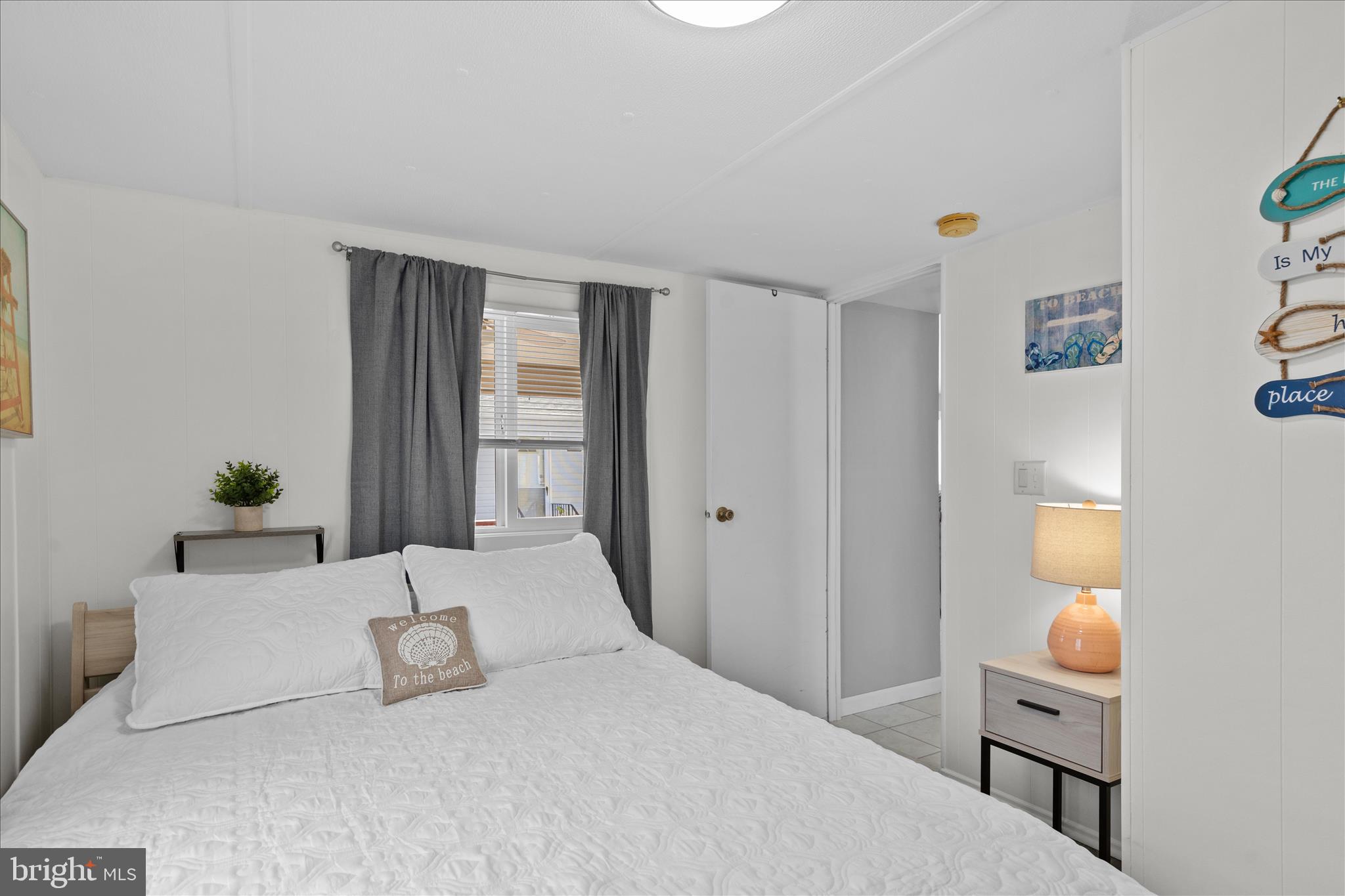 25760 Blue Ridge Street Millsboro, DE 19966 - Photo 33 of 64 a bedroom with a bed and a potted plant