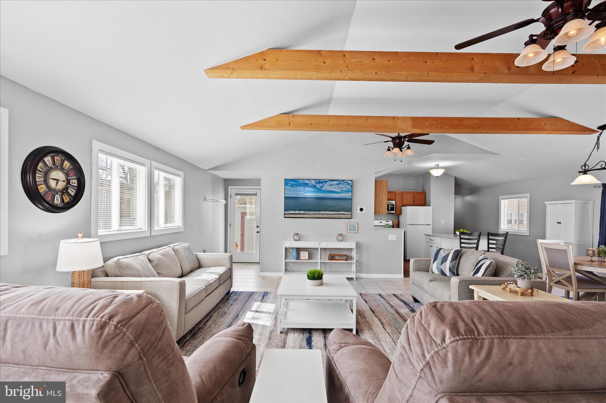 25760 Blue Ridge Street Millsboro, DE 19966 - Photo 4 of 64 a living room with furniture a clock and a view of kitchen