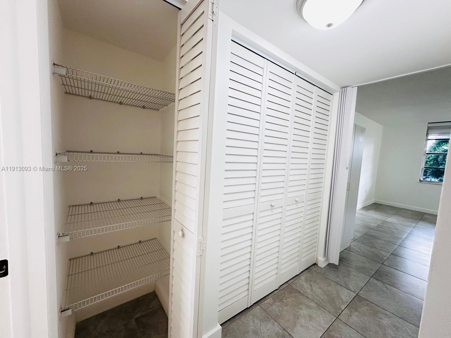 3490 Foxcroft Road, Unit B208 Miramar, FL 33025 - Photo 18 of 32 a view of walk in closet with empty racks