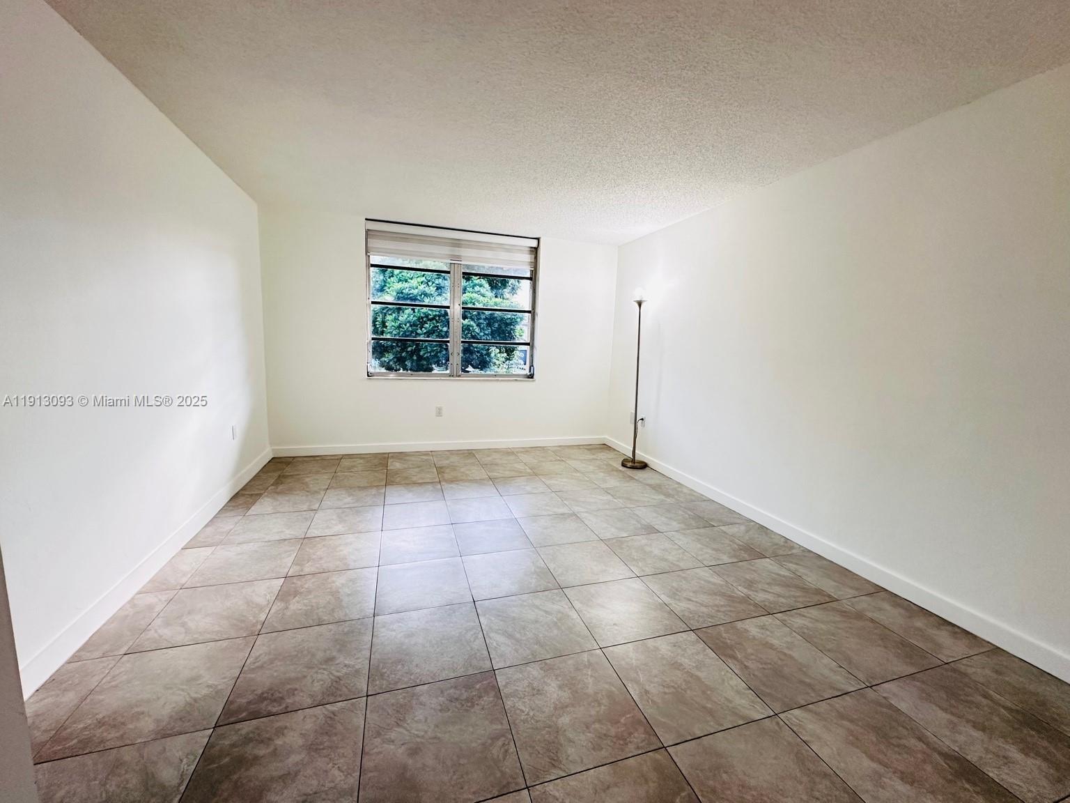 3490 Foxcroft Road, Unit B208 Miramar, FL 33025 - Photo 21 of 32 a view of an empty room with a window