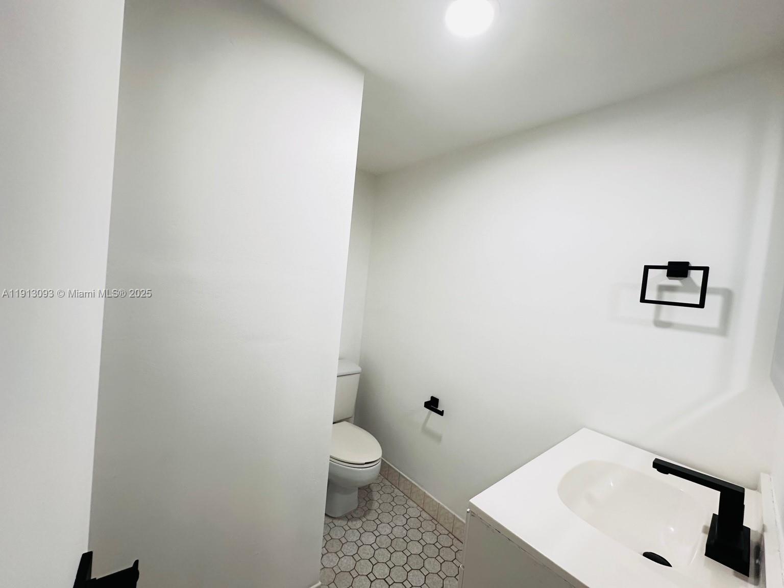 3490 Foxcroft Road, Unit B208 Miramar, FL 33025 - Photo 31 of 32 a bathroom with a sink and a toilet