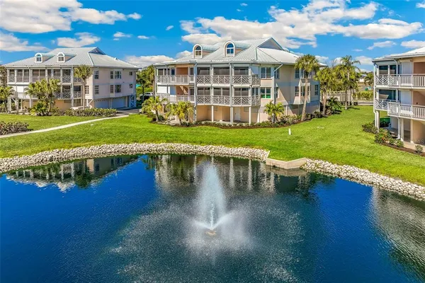 a view of a house with a big yard and large trees