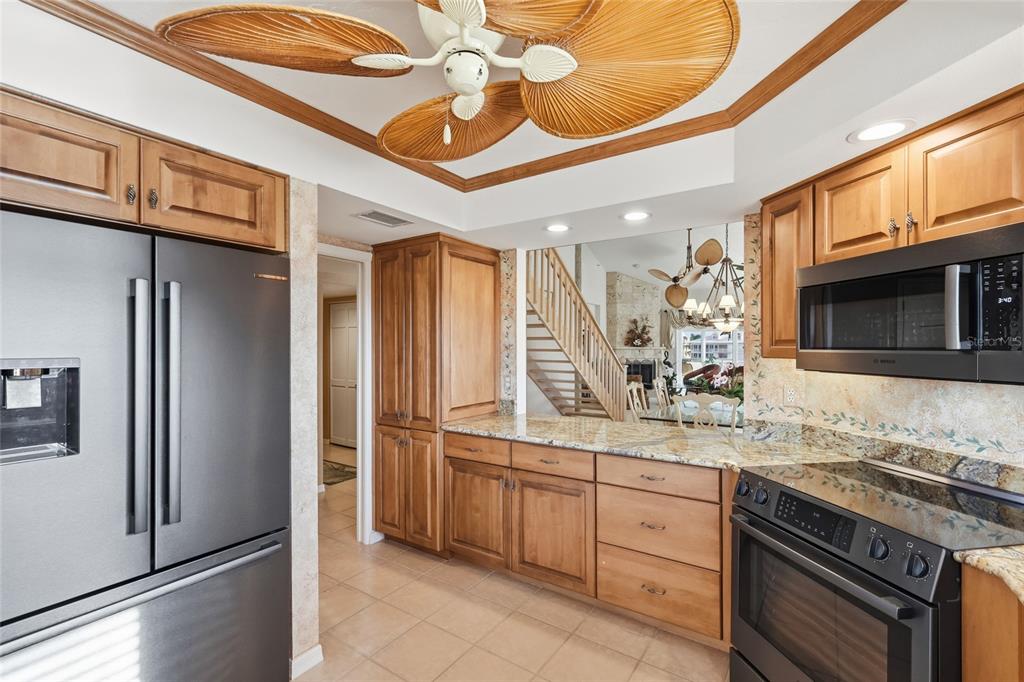 11000 Placida Road, Unit 1504 Placida, FL 33946 - Photo 11 of 73 a kitchen with stainless steel appliances granite countertop a refrigerator a stove and a sink with dishwasher