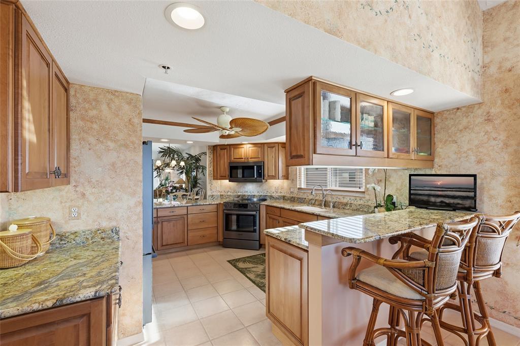 11000 Placida Road, Unit 1504 Placida, FL 33946 - Photo 13 of 73 a kitchen with a stove a sink and a refrigerator