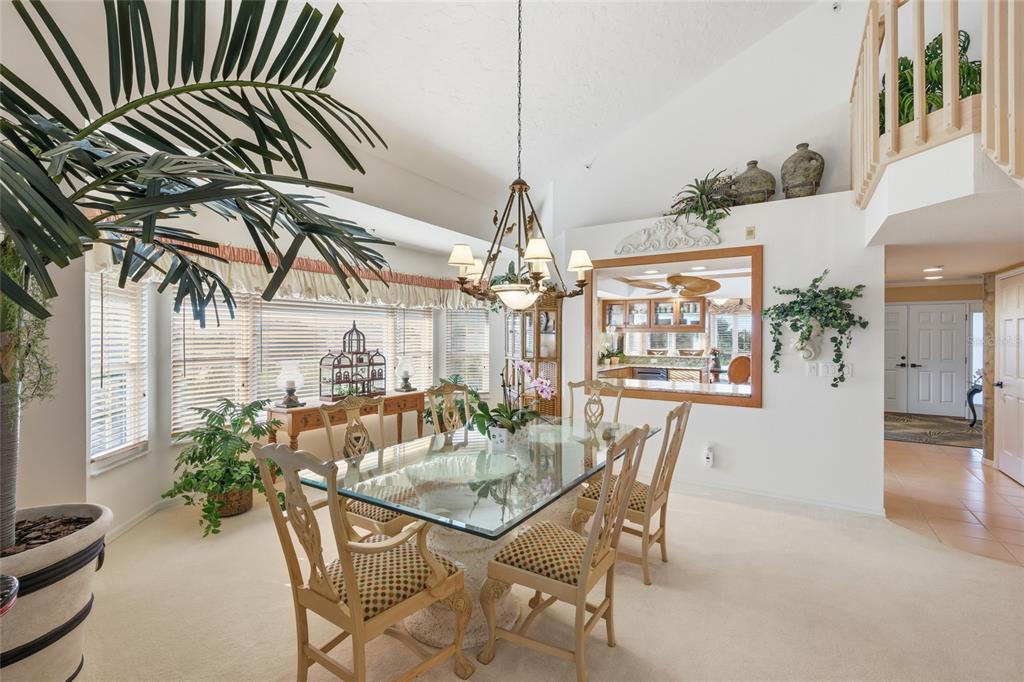 11000 Placida Road, Unit 1504 Placida, FL 33946 - Photo 15 of 73 a view of a dining room with furniture and a chandelier