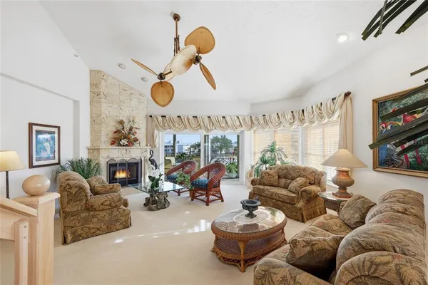 a living room with furniture kitchen view and a fireplace