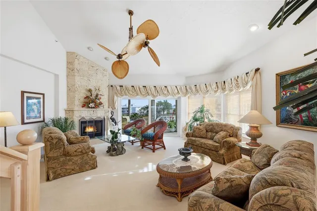 a living room with furniture kitchen view and a fireplace