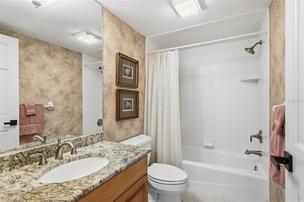 11000 Placida Road, Unit 1504 Placida, FL 33946 - Photo 36 of 73 a bathroom with a granite countertop sink toilet and shower