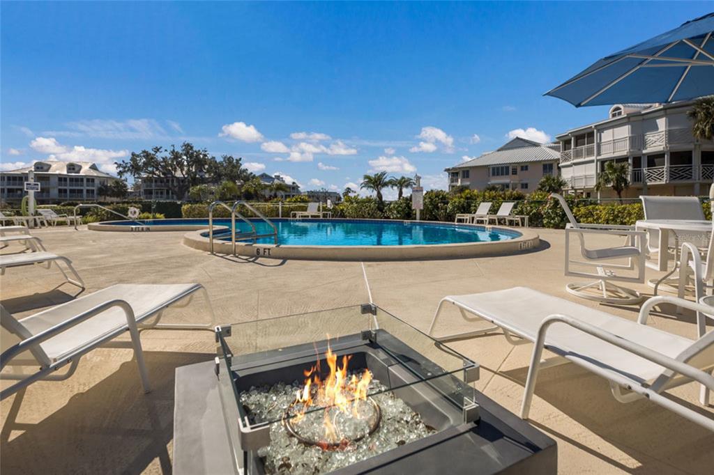 11000 Placida Road, Unit 1504 Placida, FL 33946 - Photo 51 of 73 a view of a swimming pool with lounge chairs